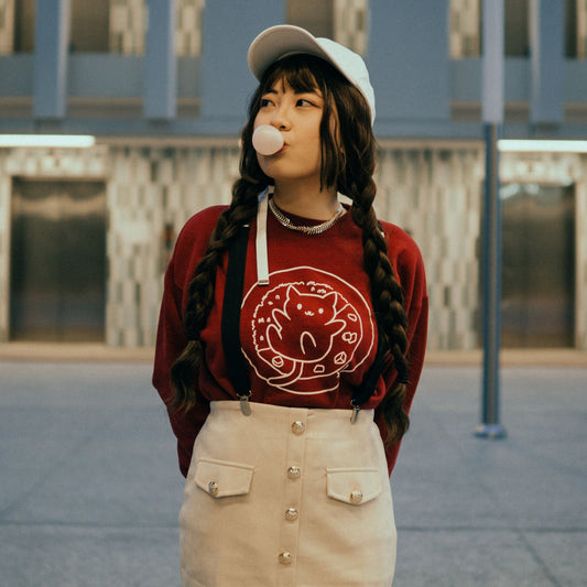 girl wearing red catsu curry cat crewneck sweater